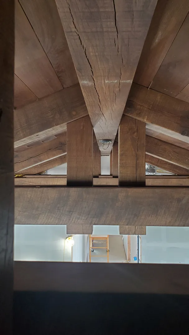 Centered view through the layered exposed timber roof framing at Perryton.