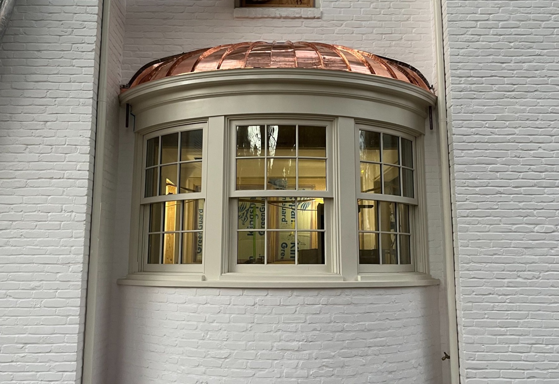Curved copper bay assembled through coordinated framing, substrate, and finished metal detailing.